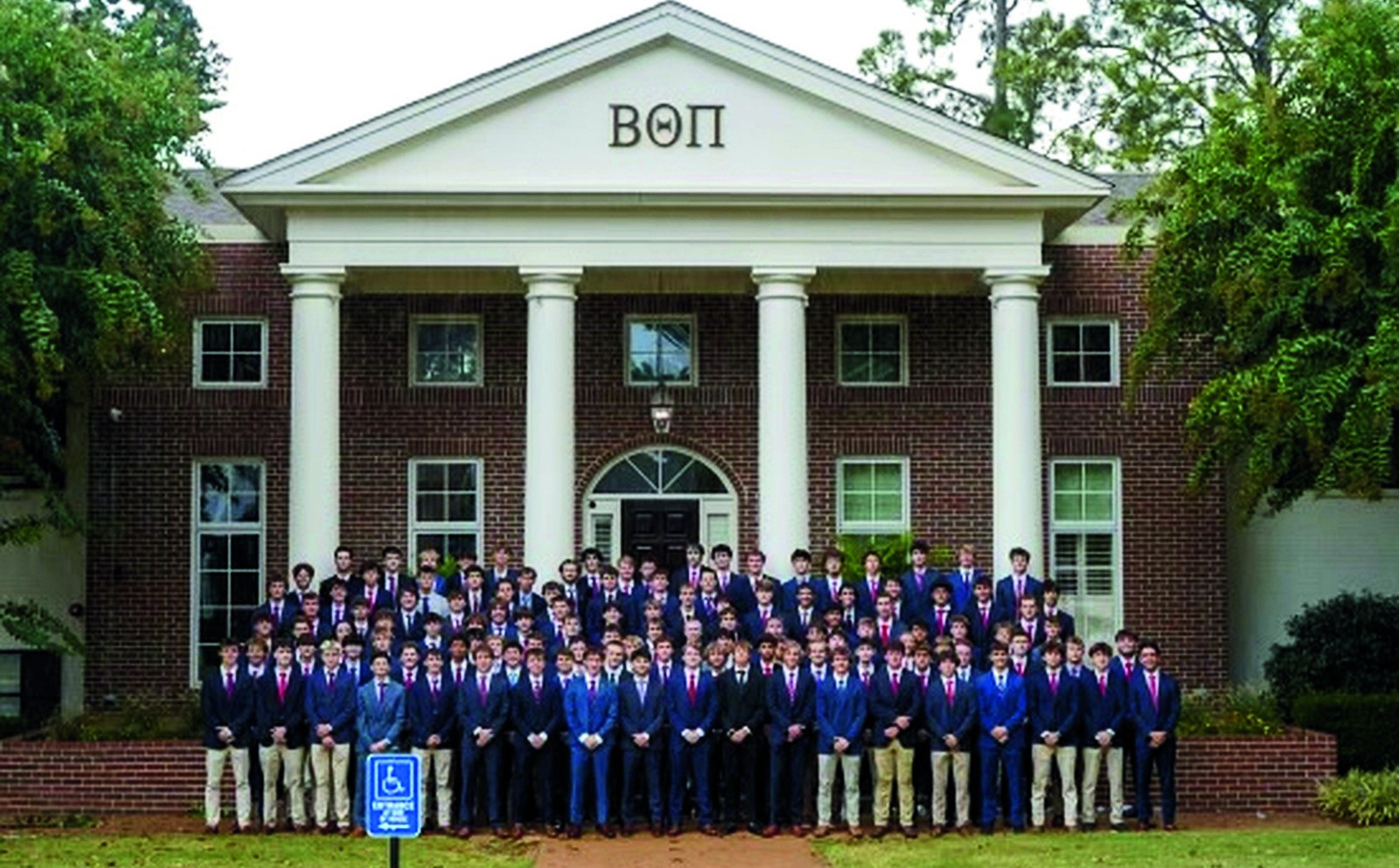 Beta Beta members gathered in front of the columned chapter house before the 2026 expansion